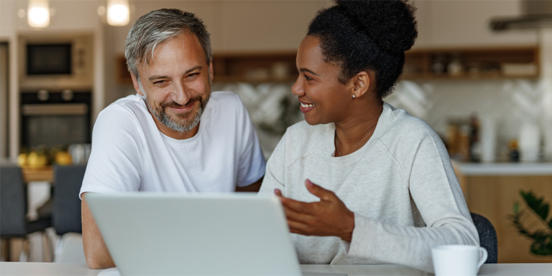 Couple reviewing home and car insurance policy online