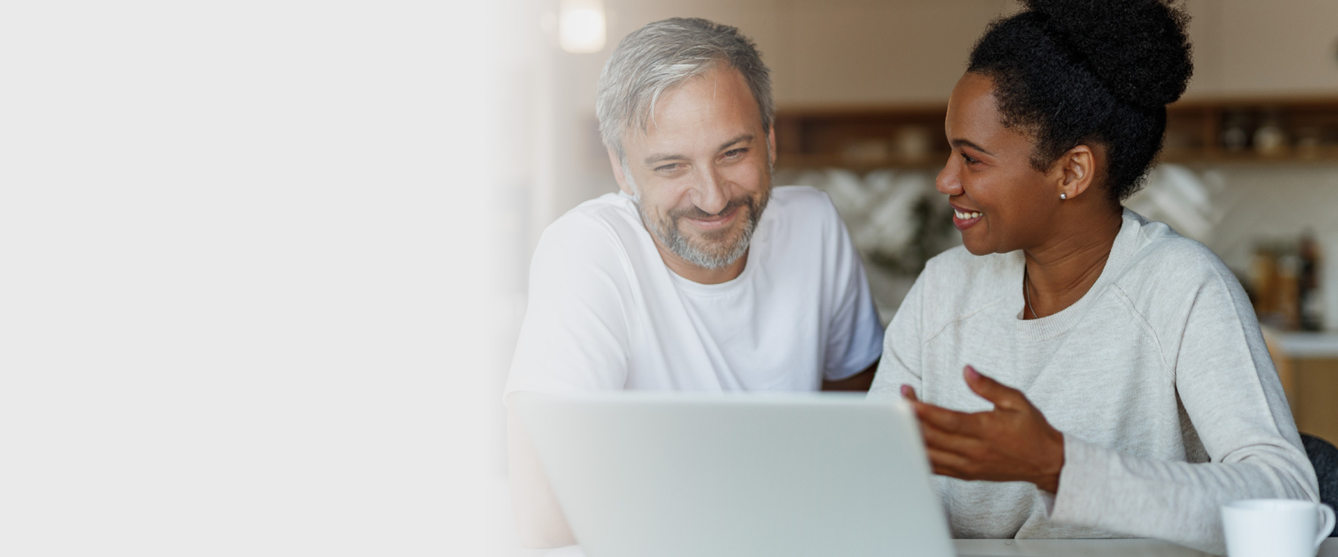 Couple reviewing home and car insurance policy online
