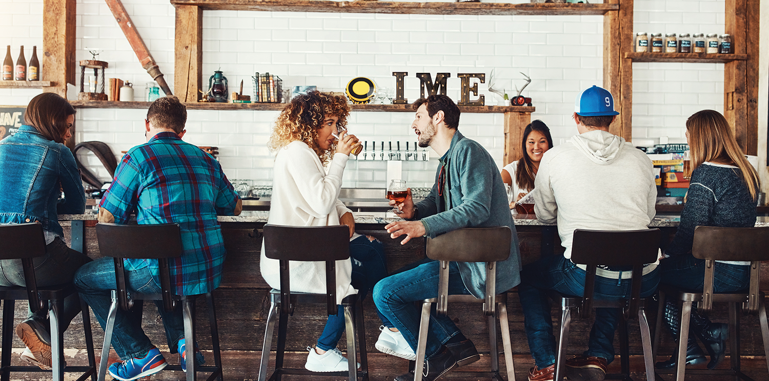 Middle Age Males and Females sitting at a Bar