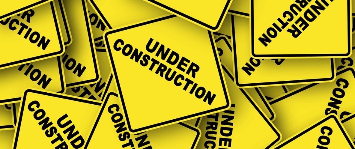 Pile of Under Construction signs