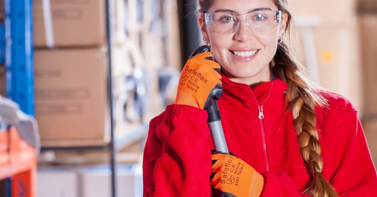 Woman wearing safety goggles and protective gloves