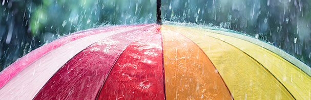 Close up of rain coming down on the top of an umbrella