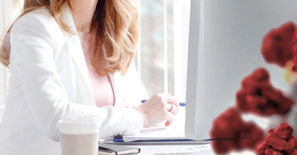 Woman at her desk working with coronavirus image