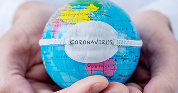 Hands holding a small globe with a band across the globe that reads Coronavirus