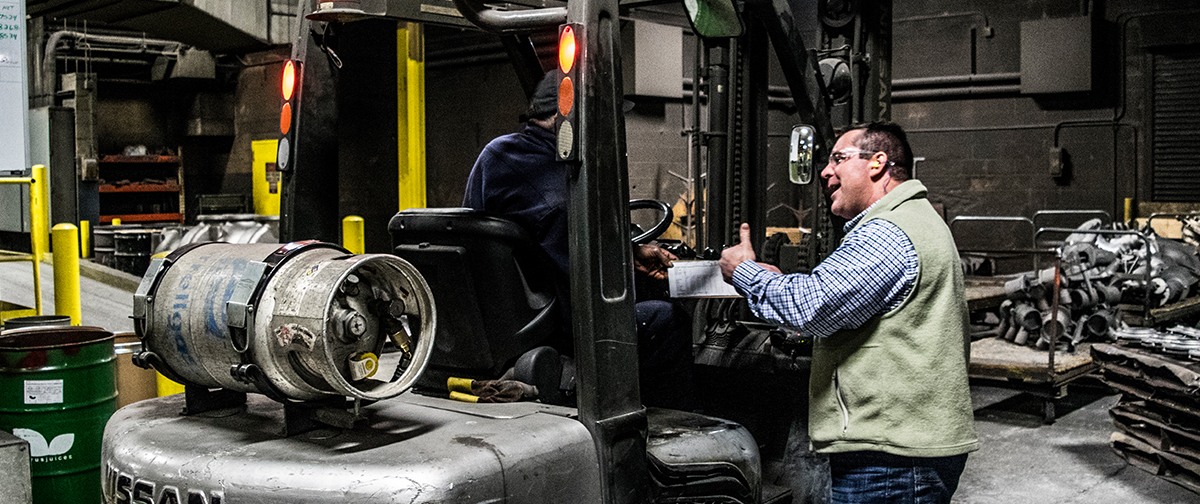 Man speaking to forklift operator