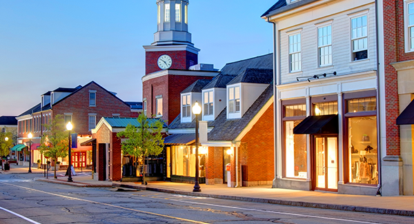 empty downtown street, buildings lit up