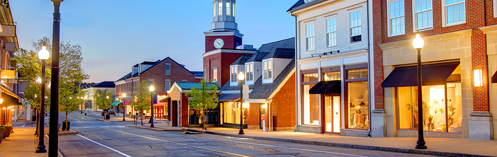 empty downtown street, buildings lit up